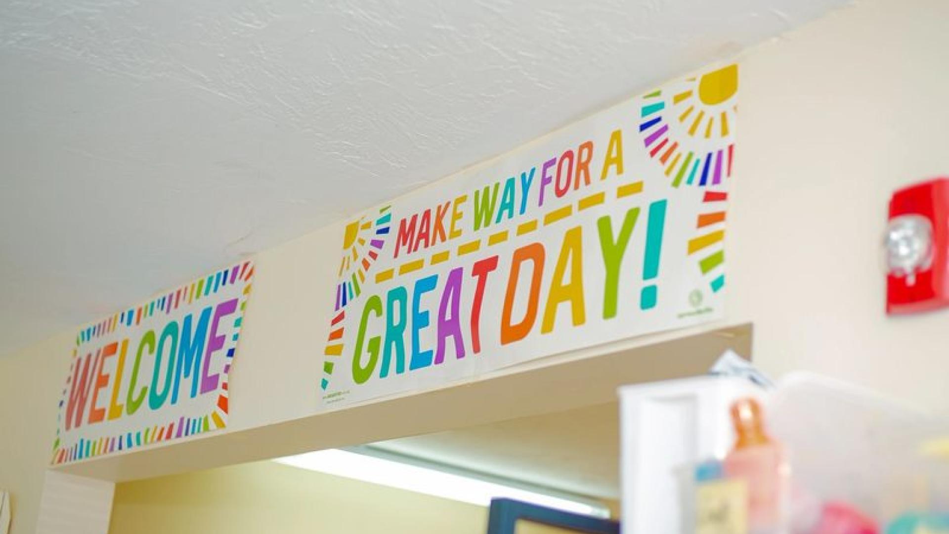 A bright classroom wall welcoming children to a great day