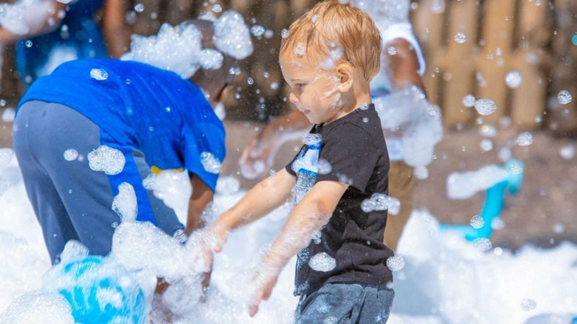 A child discovering foam play outdoors